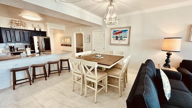 dining area with a textured ceiling, marble finish floor, a chandelier, and crown molding