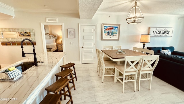 dining space with visible vents, a textured ceiling, and ornamental molding