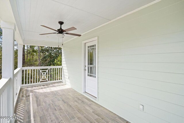 wooden deck featuring a ceiling fan