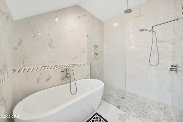 full bathroom featuring a freestanding tub, vaulted ceiling, a walk in shower, tile walls, and marble finish floor