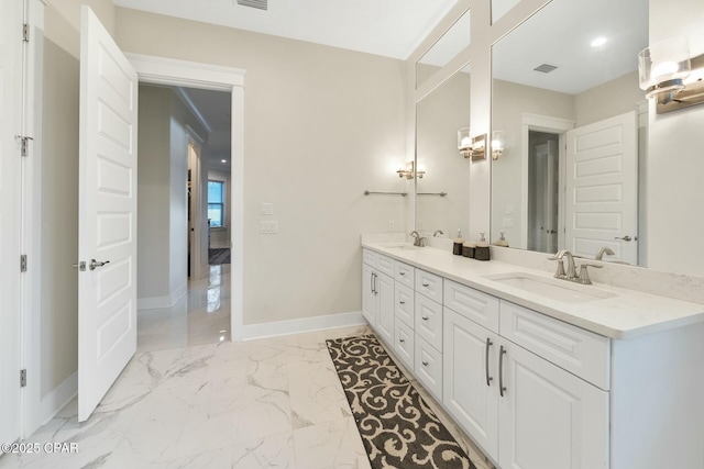 full bath featuring visible vents, marble finish floor, baseboards, and a sink