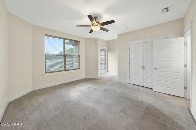 unfurnished bedroom featuring a closet, visible vents, baseboards, and carpet