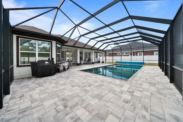 view of swimming pool with a fenced in pool, ceiling fan, a lanai, a fenced backyard, and a patio area