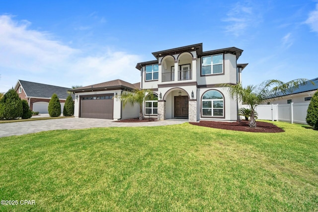 view of front of house with fence, an attached garage, stucco siding, a front lawn, and decorative driveway