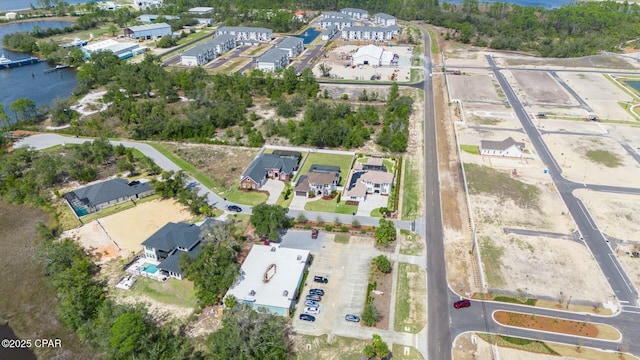 bird's eye view featuring a water view and a residential view