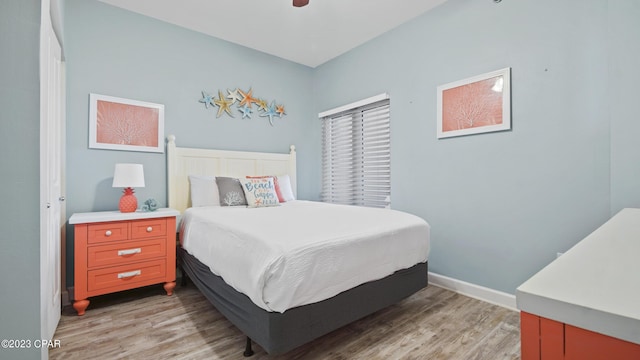 bedroom with baseboards and light wood finished floors