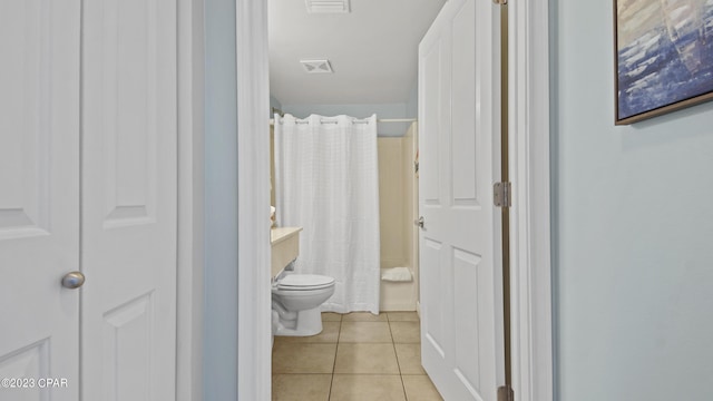 bathroom with tile patterned flooring, visible vents, curtained shower, and toilet