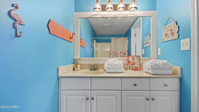 bathroom with visible vents, a shower with curtain, and vanity