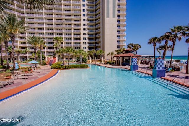 view of swimming pool with a gazebo and a water view