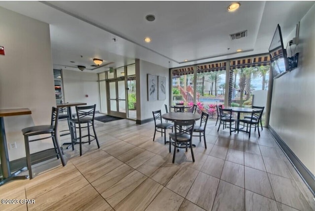 dining space with baseboards and visible vents