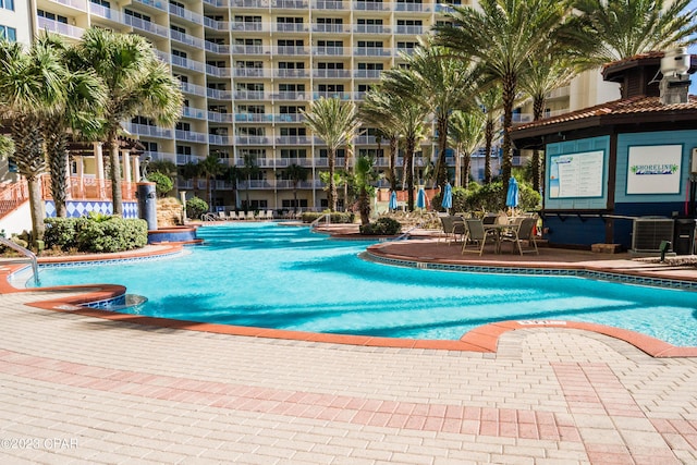 view of pool featuring cooling unit