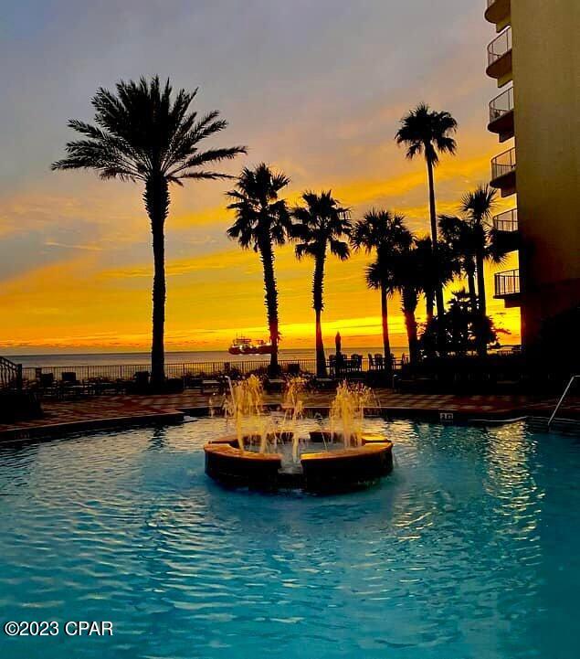 pool at dusk with a water view