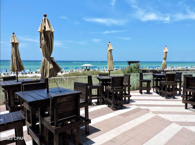 view of patio / terrace featuring outdoor dining area and a water view