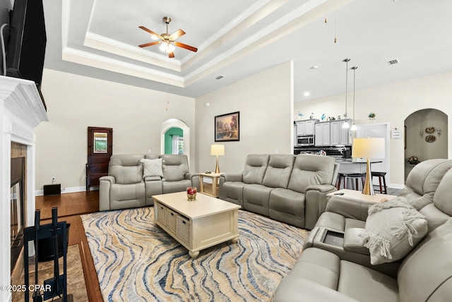 116 Lake Merial Blvd, Panama City, FL 32409 - living room featuring arched walkways, ceiling fan, ornamental molding, baseboards, and light wood-style floors