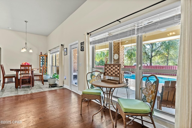 116 Lake Merial Blvd, Panama City, FL 32409 - dining space with wood finished floors, a chandelier, healthy amount of natural light, baseboards, and a towering ceiling