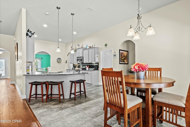 116 Lake Merial Blvd, Panama City, FL 32409 - dining area featuring arched walkways, a chandelier, and recessed lighting