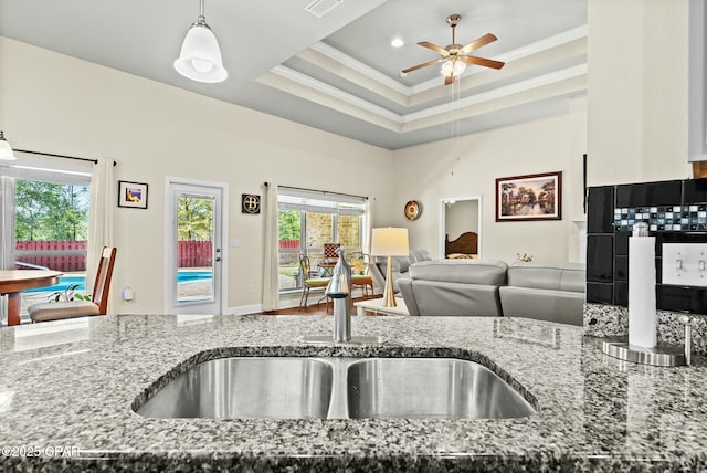 116 Lake Merial Blvd, Panama City, FL 32409 - kitchen with ornamental molding, a sink, stone countertops, ceiling fan, and open floor plan