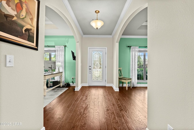 116 Lake Merial Blvd, Panama City, FL 32409 - entrance foyer with arched walkways, dark wood-style floors, ornamental molding, healthy amount of natural light, and baseboards