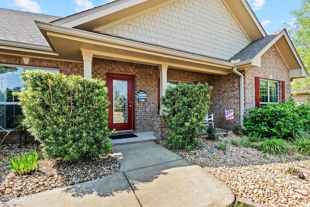 116 Lake Merial Blvd, Panama City, FL 32409 - view of exterior entry featuring brick siding, a shingled roof, and covered porch