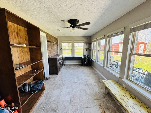 7224 Resota Ln, Panama City, FL 32409 - sunroom featuring baseboards, stone finish floor, and a textured ceiling