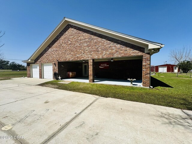7224 Resota Ln, Panama City, FL 32409 - view of property exterior with concrete driveway, brick siding, and a lawn