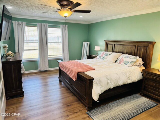 7224 Resota Ln, Panama City, FL 32409 - bedroom featuring a ceiling fan, ornamental molding, a textured ceiling, and wood finished floors