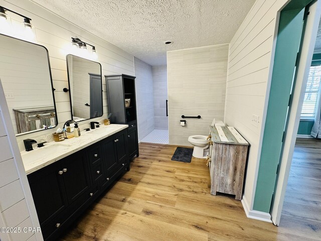 7224 Resota Ln, Panama City, FL 32409 - full bath with wood walls, toilet, tiled shower, and wood finished floors