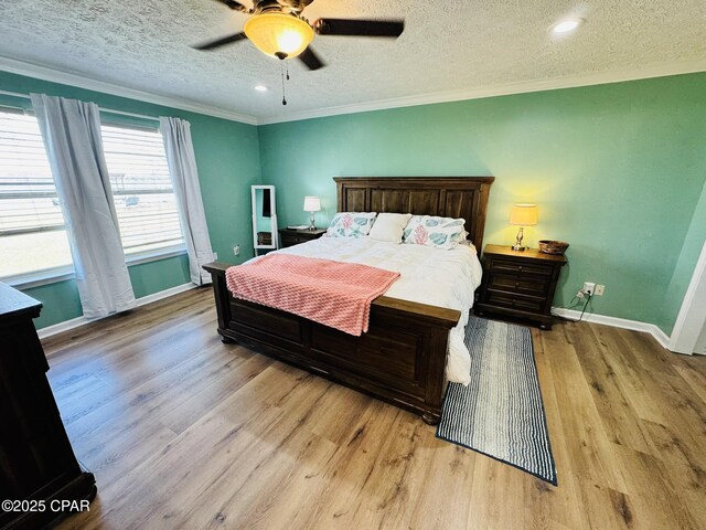 7224 Resota Ln, Panama City, FL 32409 - bedroom with wood finished floors, ornamental molding, a textured ceiling, a ceiling fan, and baseboards