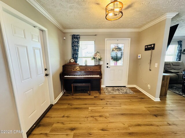 7224 Resota Ln, Panama City, FL 32409 - foyer entrance featuring baseboards, ornamental molding, a textured ceiling, and wood finished floors