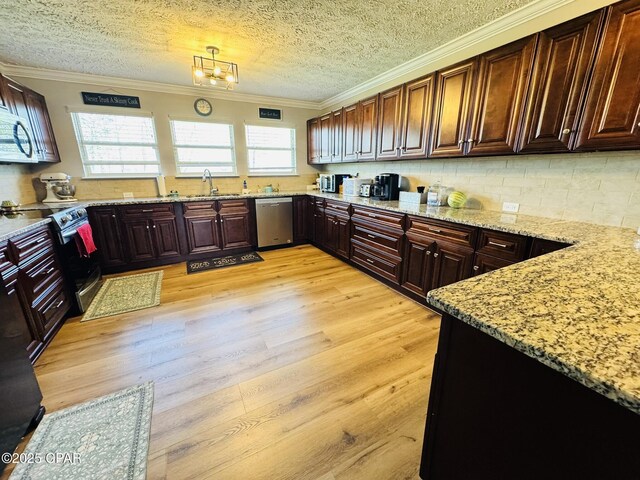 7224 Resota Ln, Panama City, FL 32409 - kitchen featuring light wood finished floors, light stone counters, stainless steel appliances, and a sink