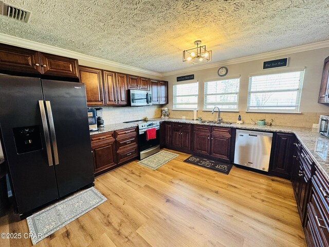 7224 Resota Ln, Panama City, FL 32409 - kitchen with a textured ceiling, stainless steel appliances, crown molding, and a sink