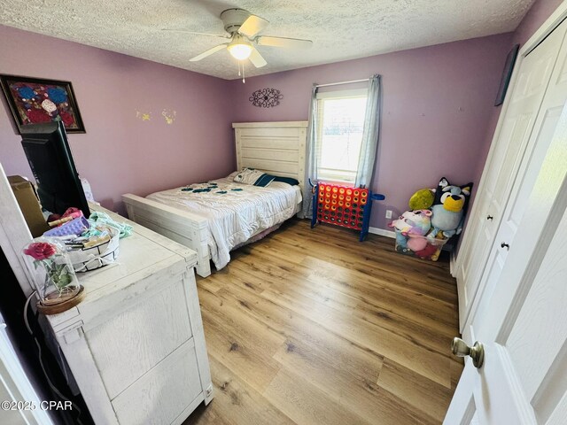 7224 Resota Ln, Panama City, FL 32409 - bedroom featuring baseboards, ceiling fan, light wood-type flooring, and a textured ceiling