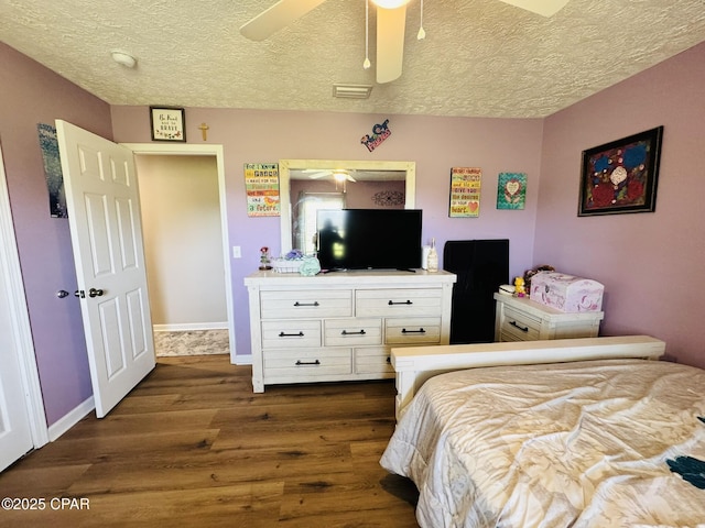 7224 Resota Ln, Panama City, FL 32409 - bedroom with dark wood-style flooring, a textured ceiling, ceiling fan, and visible vents