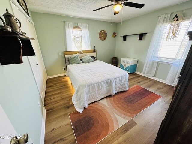 7224 Resota Ln, Panama City, FL 32409 - bedroom with a textured ceiling, wood finished floors, and multiple windows