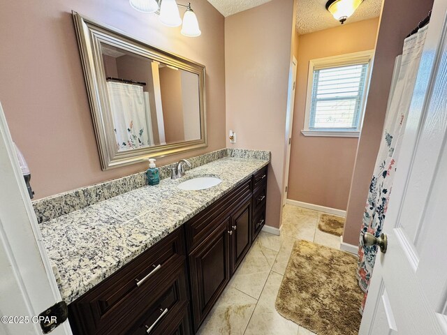 7224 Resota Ln, Panama City, FL 32409 - bathroom with a textured ceiling, baseboards, and vanity