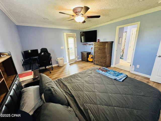 7224 Resota Ln, Panama City, FL 32409 - bedroom with ornamental molding, a textured ceiling, a ceiling fan, and wood finished floors