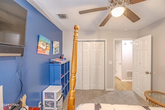 107 Summerwood Dr, Panama City Beach, FL 32413 - carpeted bedroom with a closet, ceiling fan, and a textured ceiling