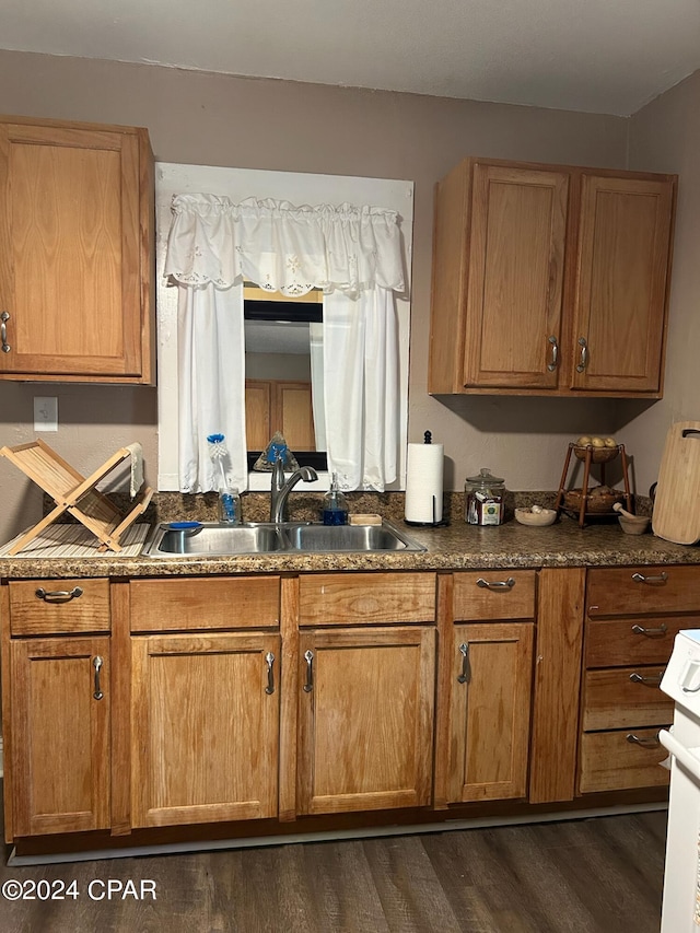 603 W Kansas Ave, Bonifay, FL 32425 - kitchen featuring a sink, range, dark wood-type flooring, and brown cabinetry