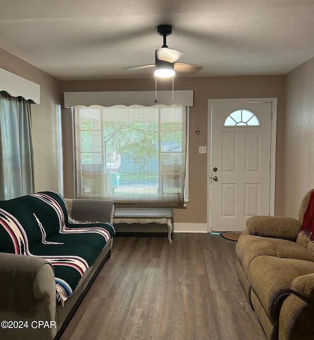 603 W Kansas Ave, Bonifay, FL 32425 - living room featuring baseboards, a textured ceiling, a ceiling fan, and wood finished floors