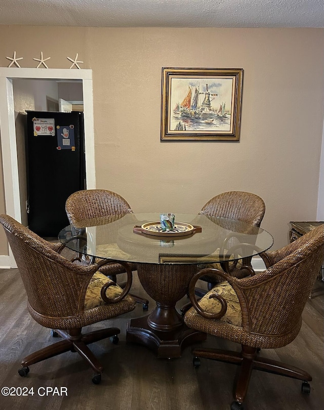 603 W Kansas Ave, Bonifay, FL 32425 - dining space featuring a textured ceiling and wood finished floors