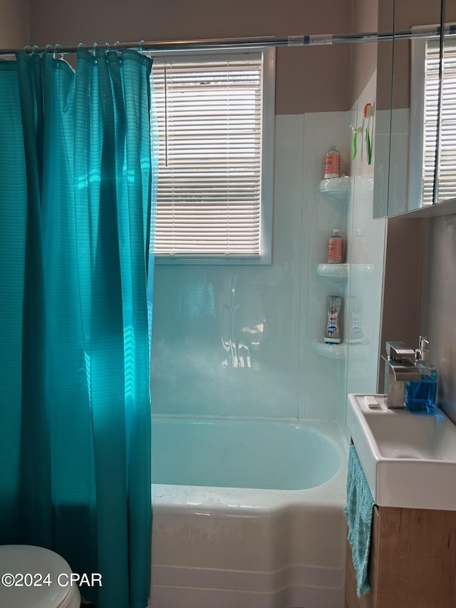 603 W Kansas Ave, Bonifay, FL 32425 - bathroom featuring shower / bath combo with shower curtain, toilet, a healthy amount of sunlight, and vanity