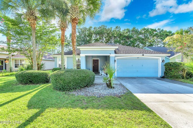 view of front of house with driveway, a shingled roof, stucco siding, a front lawn, and a garage