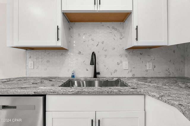 5408 Lagoon Way Unit 5, Panama City, FL 32408 - kitchen with white cabinets, light stone countertops, tasteful backsplash, and a sink