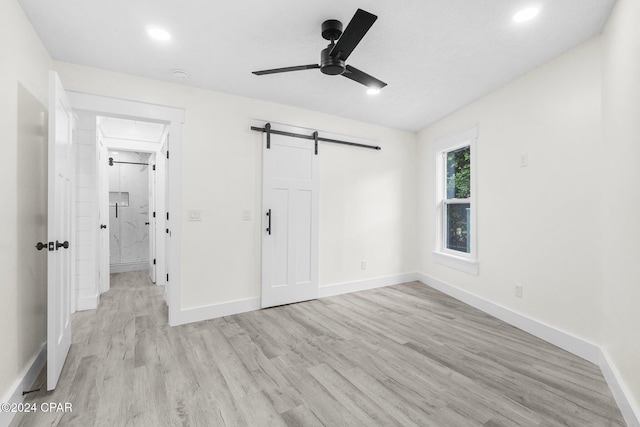 5408 Lagoon Way Unit 5, Panama City, FL 32408 - unfurnished bedroom featuring a ceiling fan, baseboards, recessed lighting, light wood-style floors, and a barn door