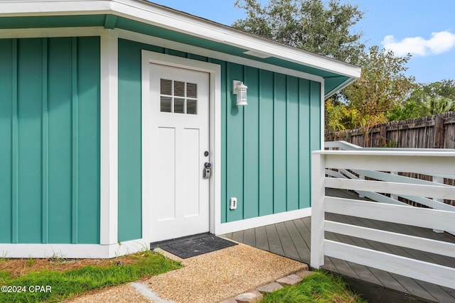 5408 Lagoon Way Unit 5, Panama City, FL 32408 - view of exterior entry featuring board and batten siding and fence