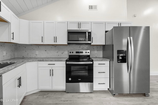 5408 Lagoon Way Unit 5, Panama City, FL 32408 - kitchen featuring lofted ceiling, backsplash, visible vents, and appliances with stainless steel finishes