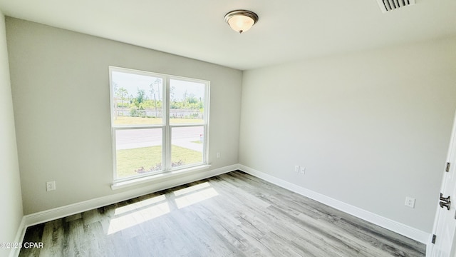 1209 Seafoam St, Panama City, FL 32404 - hall featuring arched walkways, baseboards, and light wood-style floors
