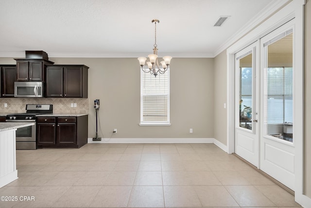 117 Cedar Hammock Ln, Panama City Beach, FL 32407 - kitchen featuring stainless steel appliances, backsplash, dark brown cabinetry, a chandelier, and crown molding