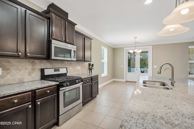 117 Cedar Hammock Ln, Panama City Beach, FL 32407 - kitchen with stainless steel appliances, a sink, a chandelier, ornamental molding, and light tile patterned floors