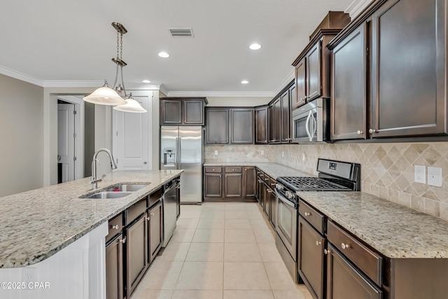 117 Cedar Hammock Ln, Panama City Beach, FL 32407 - kitchen featuring stainless steel appliances, a sink, crown molding, dark brown cabinets, and light stone counters